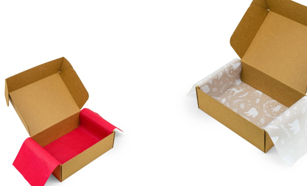 a box with red tissue paper inside next to a box with dinosaur themed tissue paper inside