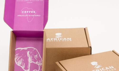 three African Coffee Club mailer boxes with pink interior and image of an elephant on the base